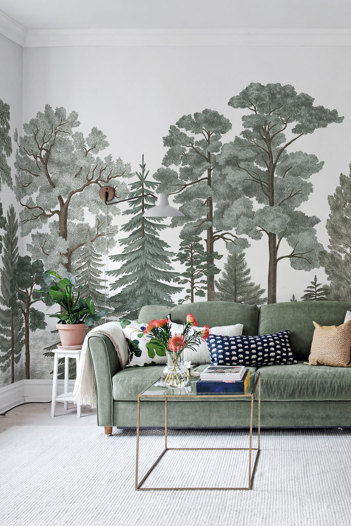 Scandinavian Forest, Mural Wallpaper in green as seen in a living area with green sofa and coffee table