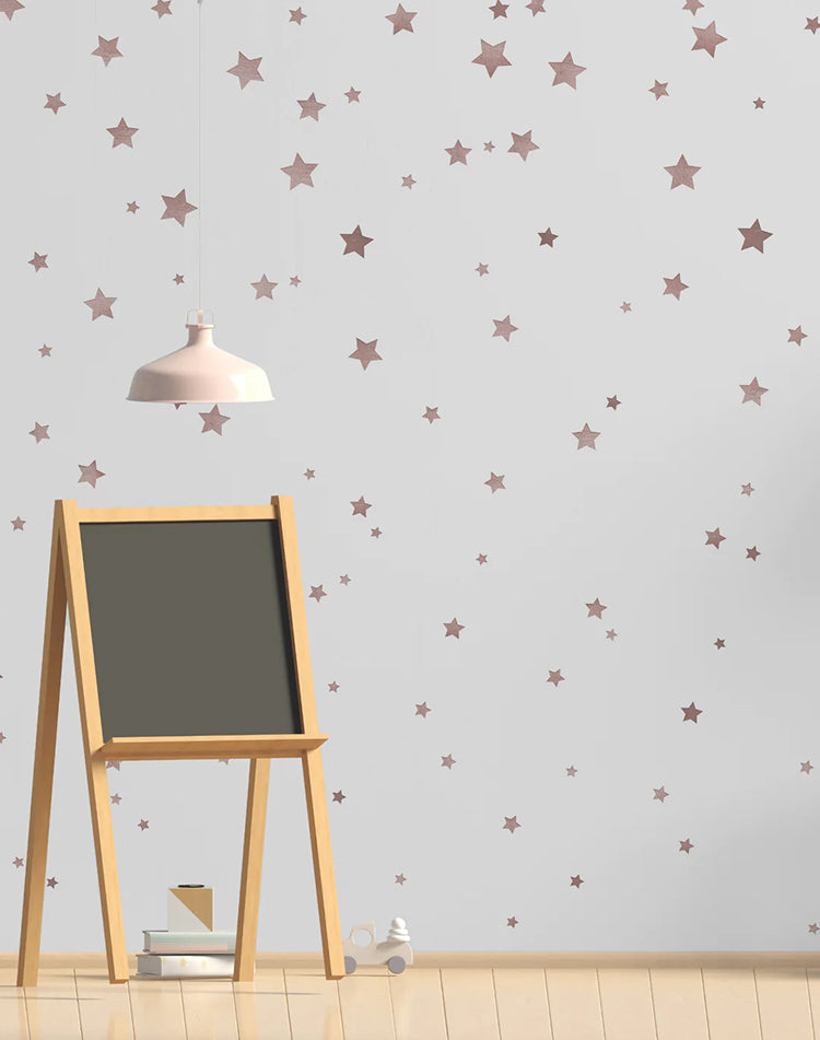 Sky Full of Stars, Pattern Wallpaper in Nude, graces a room featuring a mini chalkboard with a pendant light hanging above it.