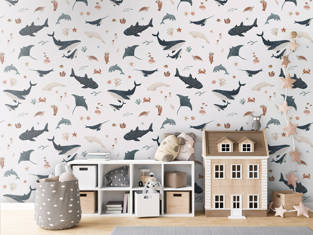 Children’s room featuring Splendid Sea white wallpaper with marine motifs, paired with wooden toys and star decorations.
