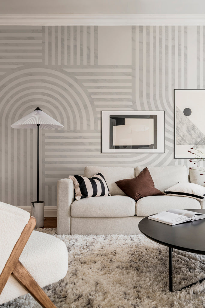 Closed up Stella Arch, Geometric Mural Wallpaper in grey featured on the wall of a living area with soft cushion and pillows