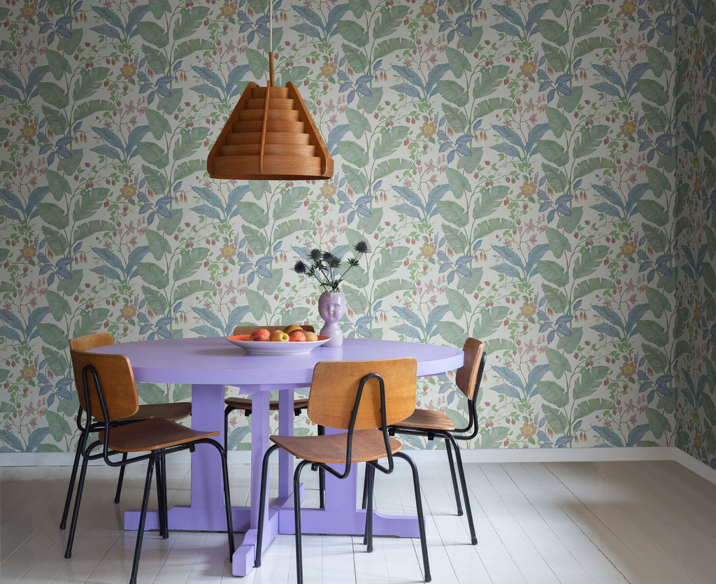Strawberry Lane, Pattern Wallpaper in Sand as seen in a dining area with purple round dining table and wooden chairs.