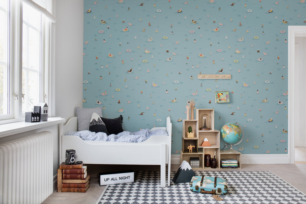 Summer by the Pool, Blue Pattern Wallpaper as seen on a wall of a child’s bedroom with checkered floor mat and stacked books 