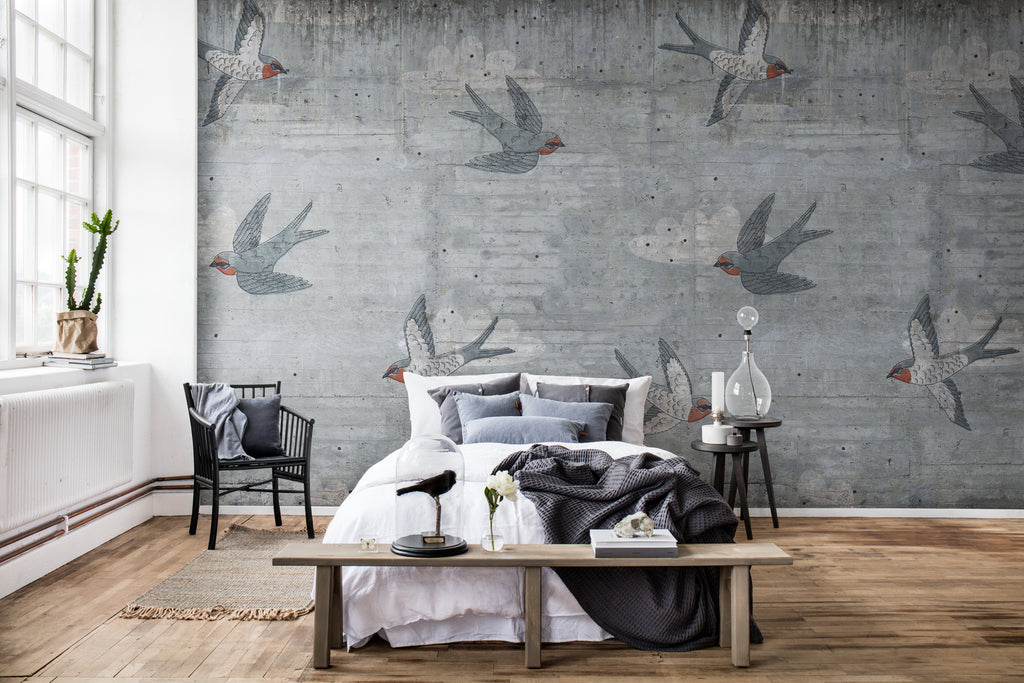 Swallow Flight, Pattern Wallpaper in grey featured on a wall of a bedroom with wood flooring and has a bed with black and white bedsheets and multiple shades of pillow