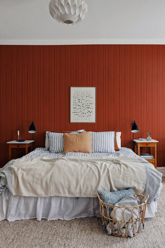 Swiss Cottage, Striped Wallpaper in crimson, featured on a wall of bed room with striped bedsheet and brown bedside tables