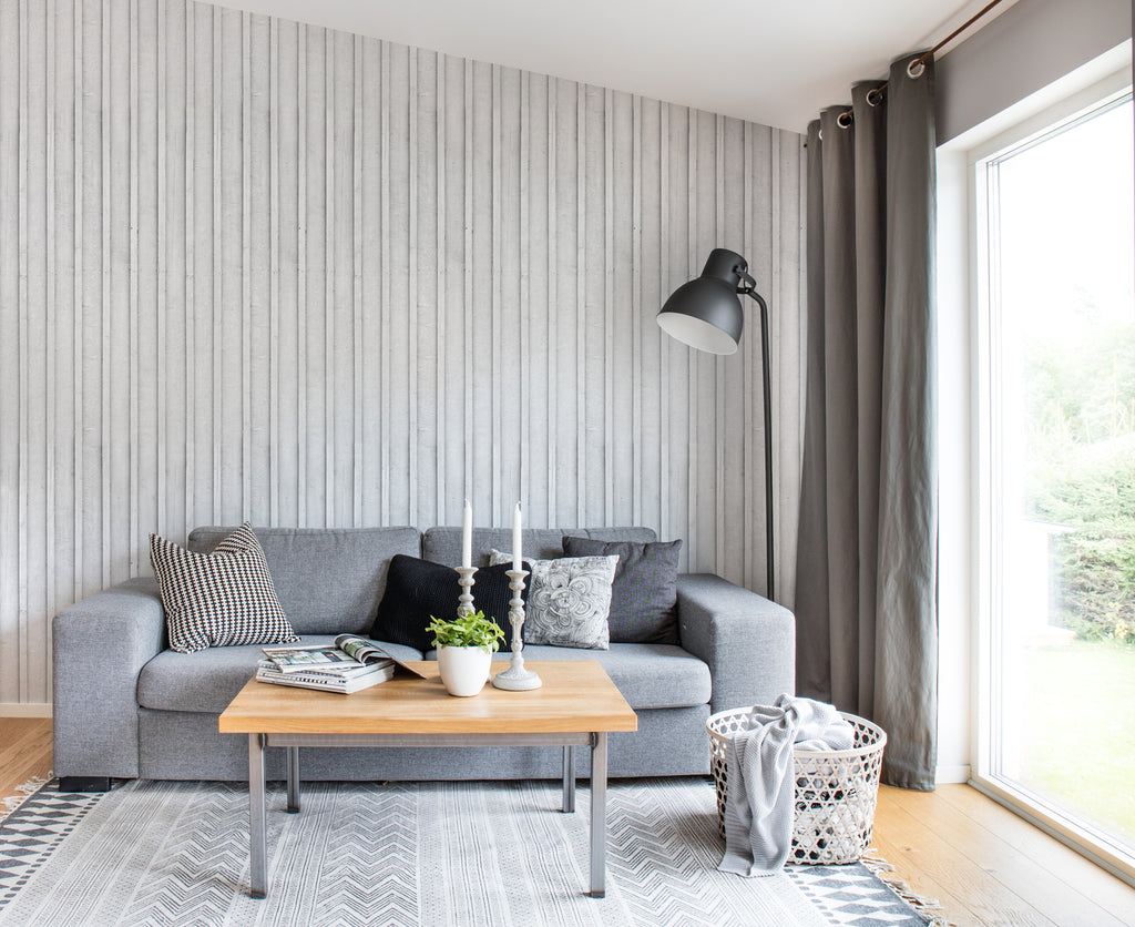 Swiss Cottage, Striped Wallpaper in light grey featured in a cozy living area with grey sofas and pillows