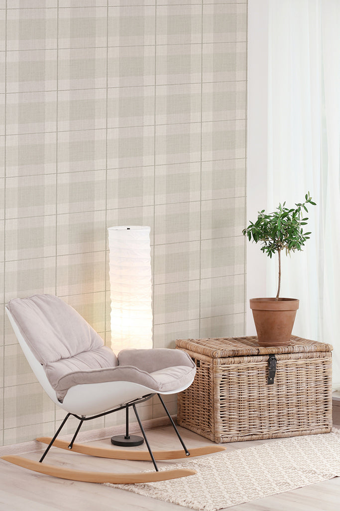 A modern room with Tartan Plaid, Pattern Wallpaper, featuring a white chair, a tall white lamp, and a green plant in a woven basket on a wooden floor.