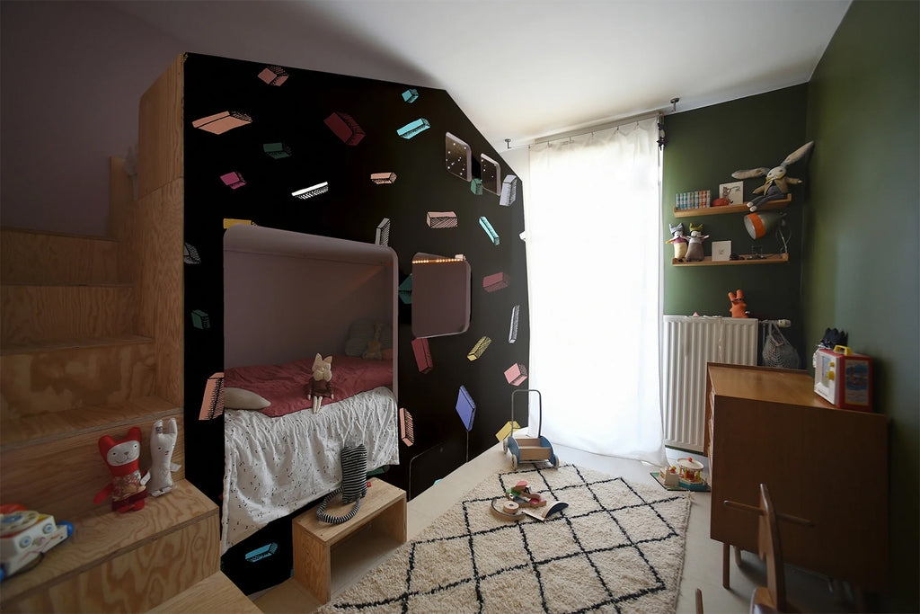A vibrant bedroom showcasing a Tetris, Pattern Wallpaper in Black, filled with colorful Tetris shapes, enhancing the room’s modern and playful vibe.
