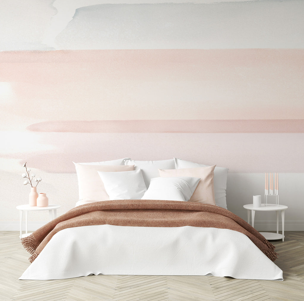 Elegant bedroom with Watercolour Pastel Brushstrokes Mural Wallpaper. Features a cozy bed with white linens, brown throw, modern side tables, and light wooden flooring.