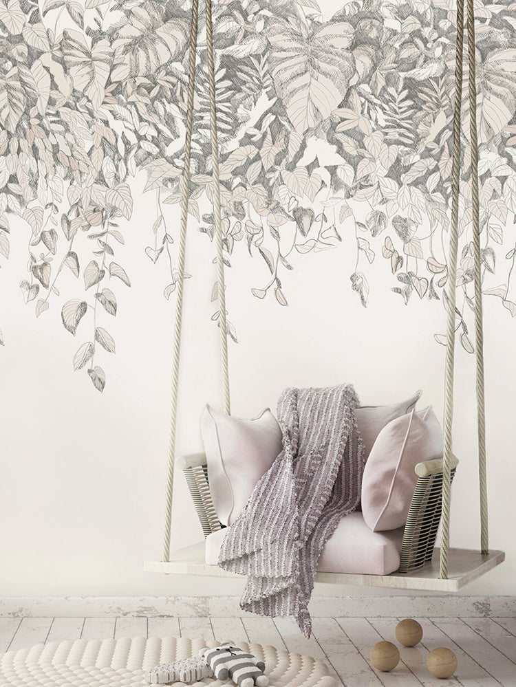 Willow Bush, Wallpaper in Nude graces a room’s wall, complemented by a white swing adorned with multiple pink pillows and a cozy grey blanket.