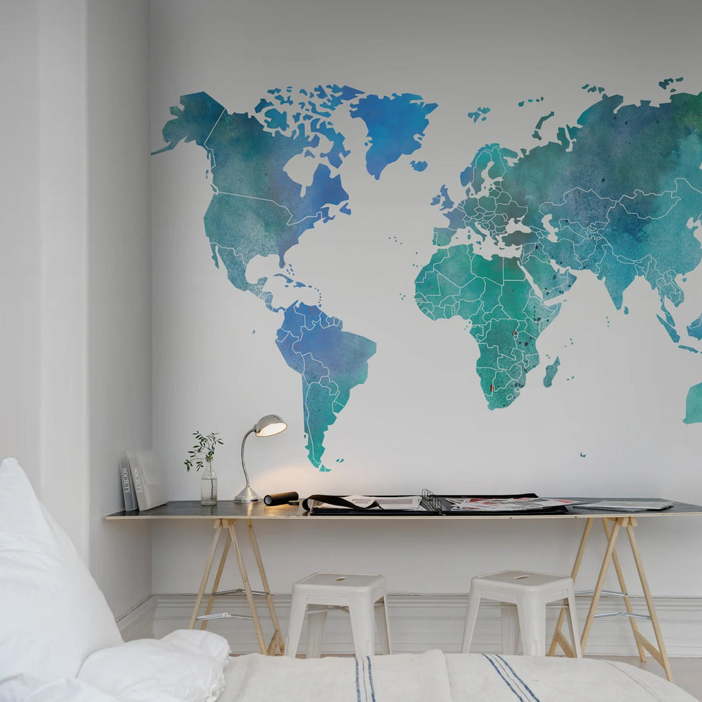  Your Own World Map, Mural Wallpaper in Emerald Green/Blue featured on a wall of a bedroom with a study table and white stool adjacent to the bed