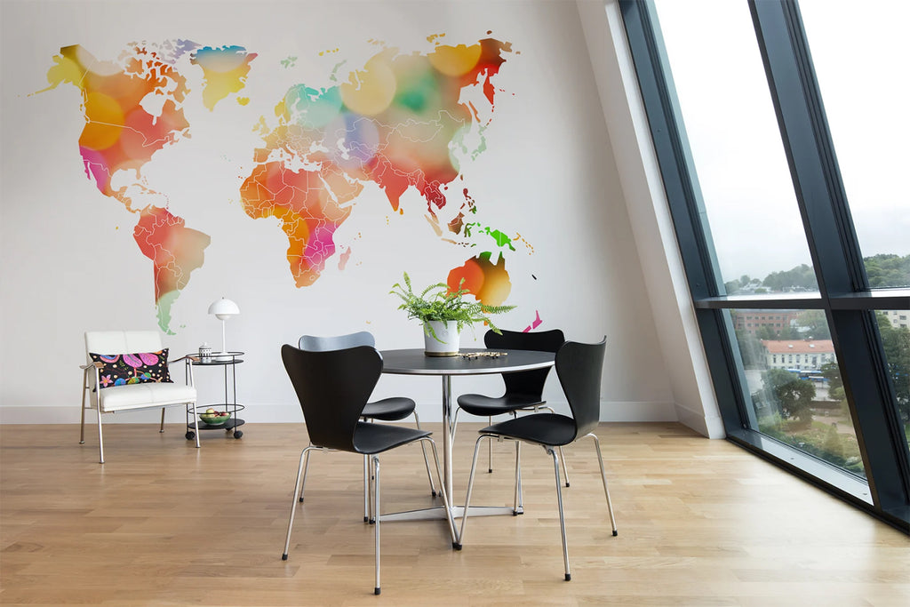 Your Own World Map, Mural Wallpaper in multicolor featured on a wall of a room with a round table with black chairs which were adjacent to the stanted curtain wall window