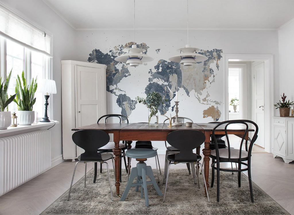 Your Own World Map, Mural Wallpaper in light grey featured on a wall of a dining area with wooden table and chairs
