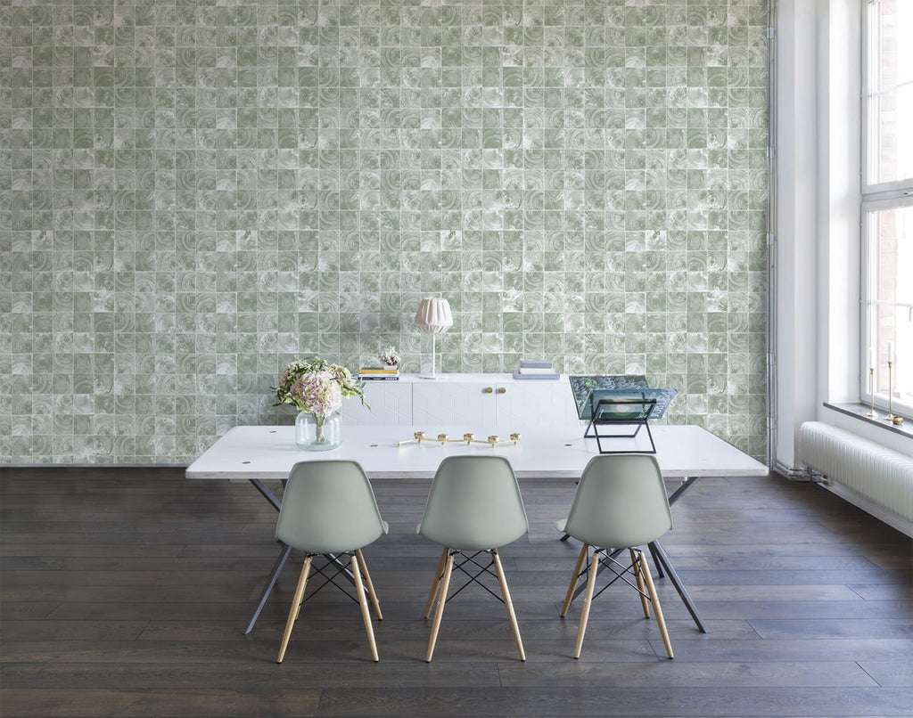 Green Reflection Patterned Wallpaper in green featured on a wall of a dining area with a white long table and a green chair