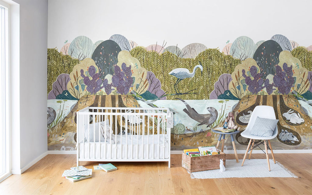 Wild Willows, Animal Mural Wallpaper featured on a wall of a child’s nursery room with white crib and white chair with wood flooring 