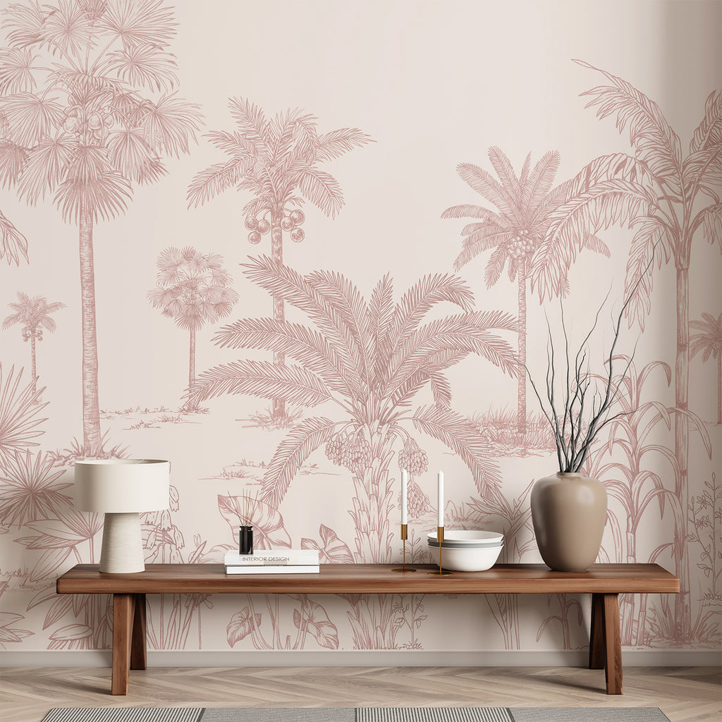 A hallway room adorned with the Vintage Palmscape, Tropical Mural Wallpaper in Rose. The monochrome mural depicts various palm trees and tropical foliage. The minimalist decor includes a wooden bench, a woven basket, potted plants, and a large window that bathes the space in natural light.