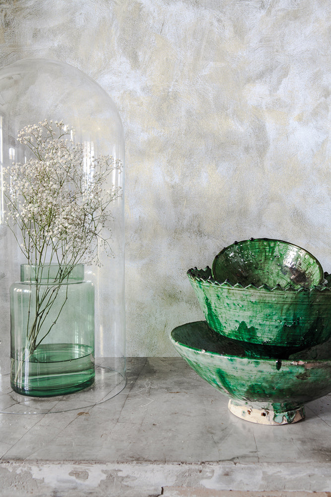 Polished Concrete Wallpaper closeup with tableware and a flower vase in front. 