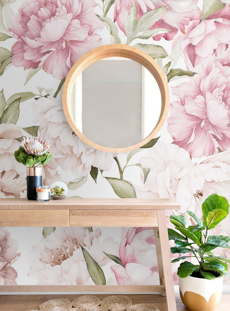 Peonies Garden wallpaper on a wall behind a mirror and a table
