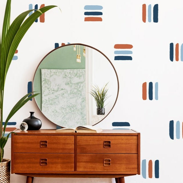Bold Lines wall decal in a room with a sideboard and round mirror on top. 