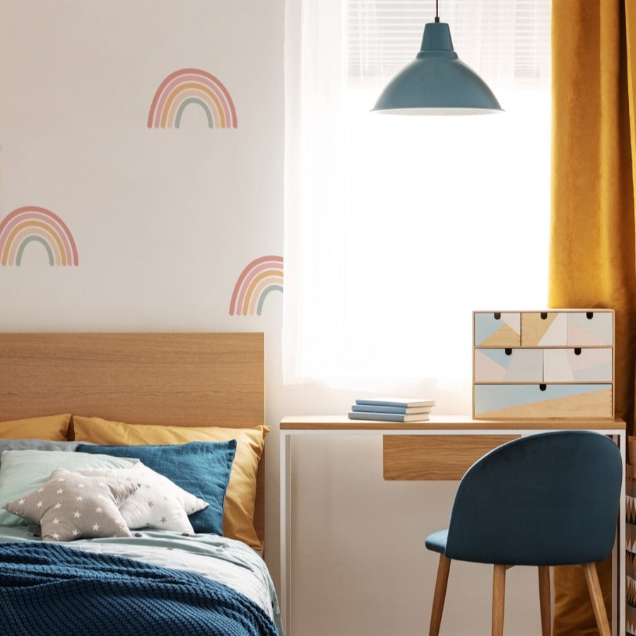 Rainbow wall decals in kids study area with desk and bed 