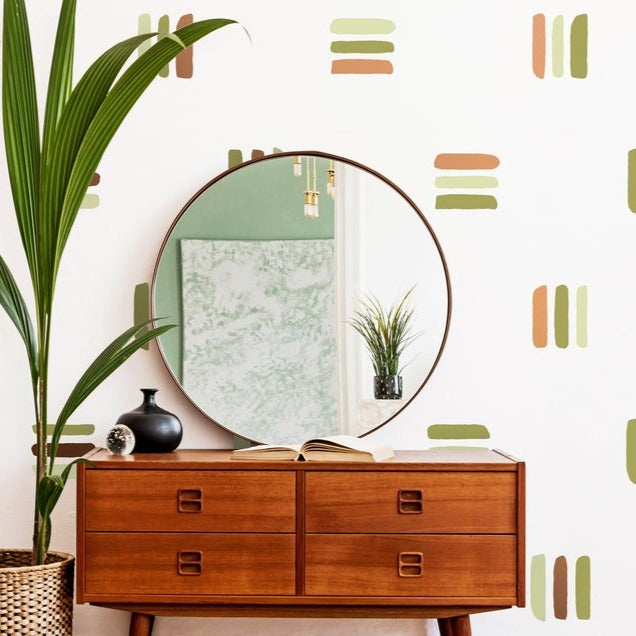 Bold Lines wall decal in a room with a sideboard and round mirror on top. 