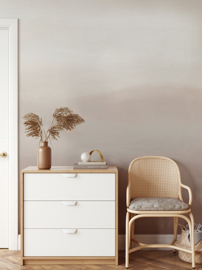 Marigold Mountain Watercolor Wallpaper in a hallway with a side console and rattan chair.