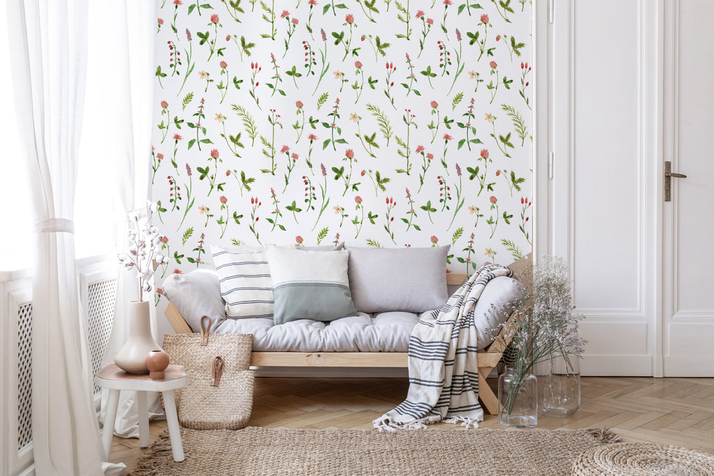 Lila, Floral Pattern Wallpaper in a cozy living room with a white and grey sofa bed, complete with several pillows and a blanket.