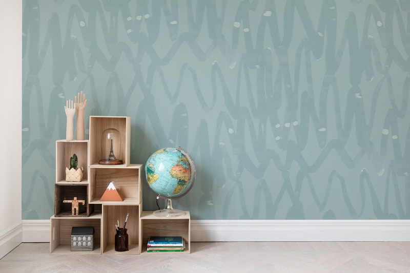 Pulse of Passion, Pattern Wallpaper in dusky blue, decorates one of the walls.