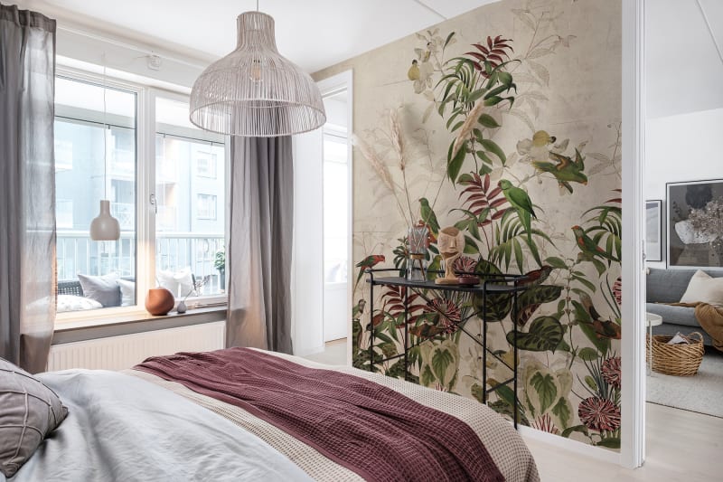 Mystical Garden, Tropical Mural Wallpaper in sand colourway in a cozy bedroom