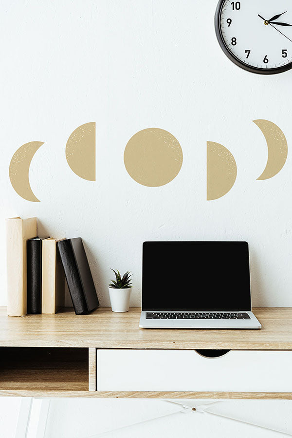 A Wall featuring Moon Phase, Wall Decals, before an overhang shelf with laptop and books on top of it. 