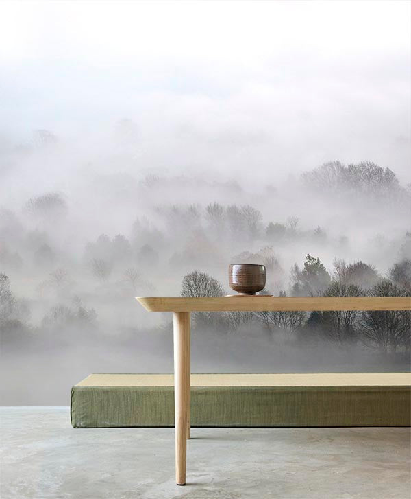 Misty Mornings, Landscape Mural Wallpaper, in a cosy living room, with a warm cup resting on a wooden table.