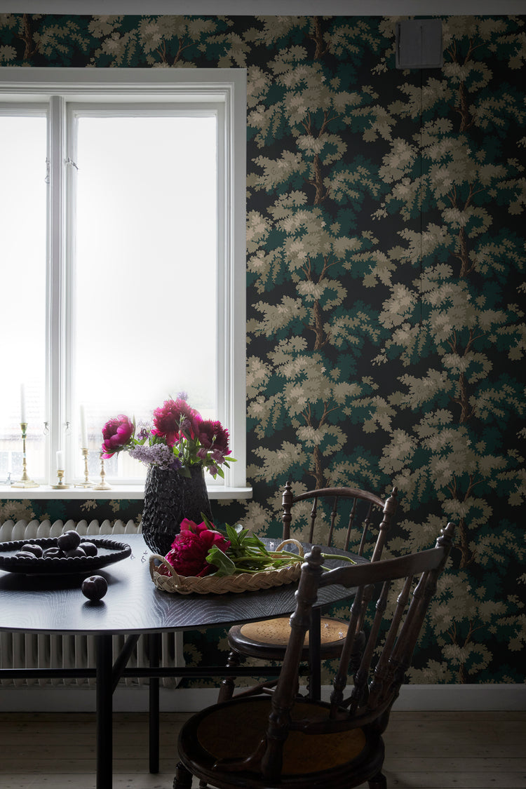 Raphael dark pattern wallpaper featuring tropical green leaves and botanical details