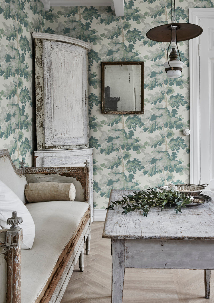 Green botanical wallpaper with bold tropical leaves and decorative floral details