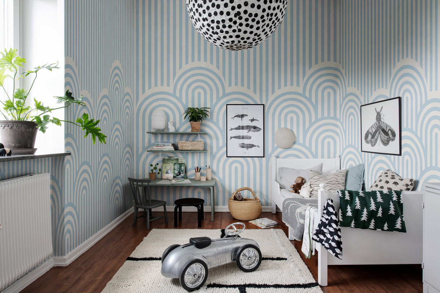 toddler boy wallpaper in light blue stripes and arches like dunes featured in bedroom