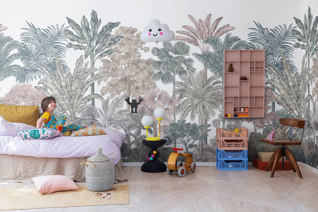 Tropical Bellewood jungle wallpaper with colourful layered trees and blooms behind a daybed, shelving and toys in a child's room