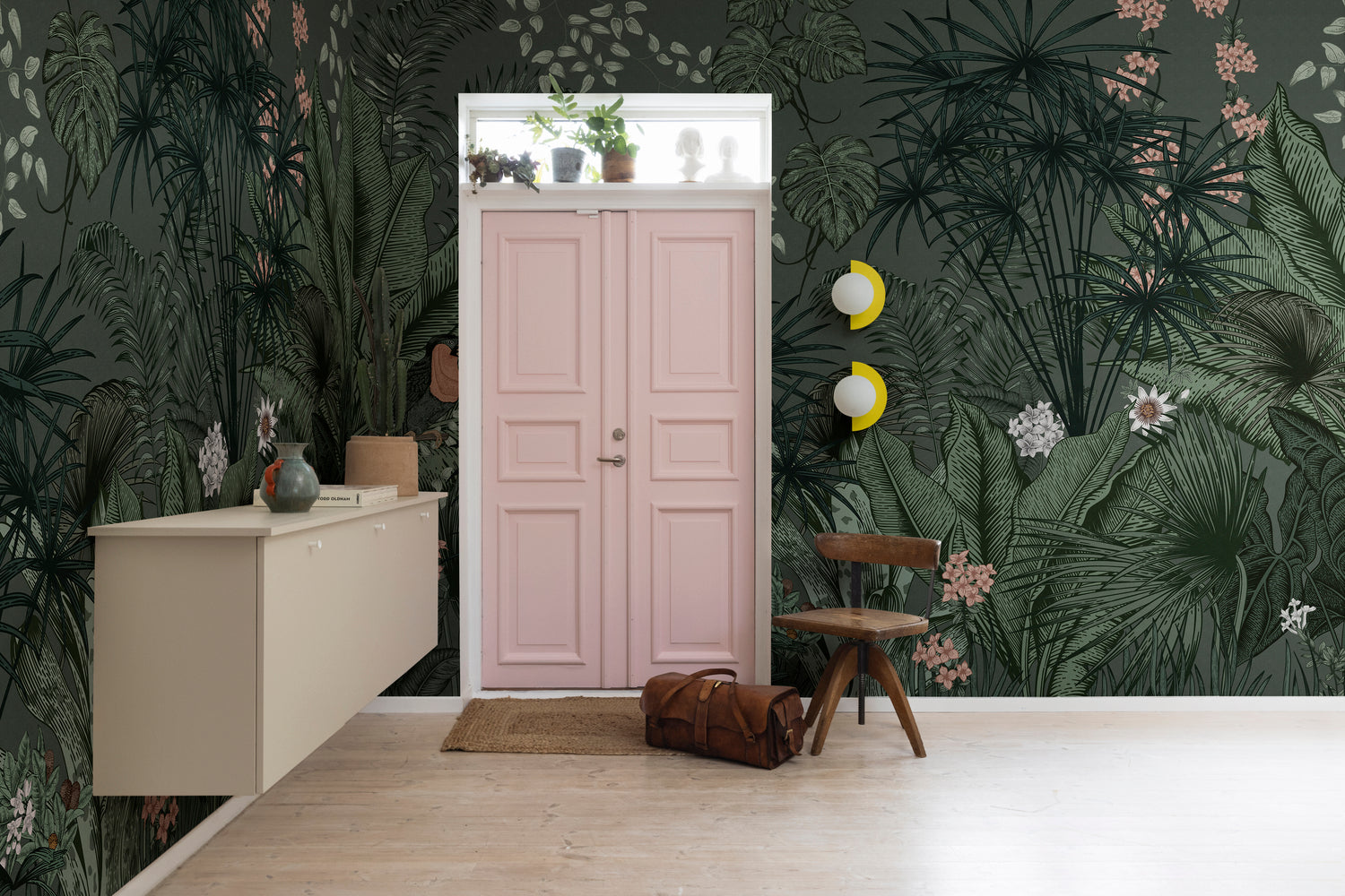 Dark green tropical mural wallpaper with oversized foliage