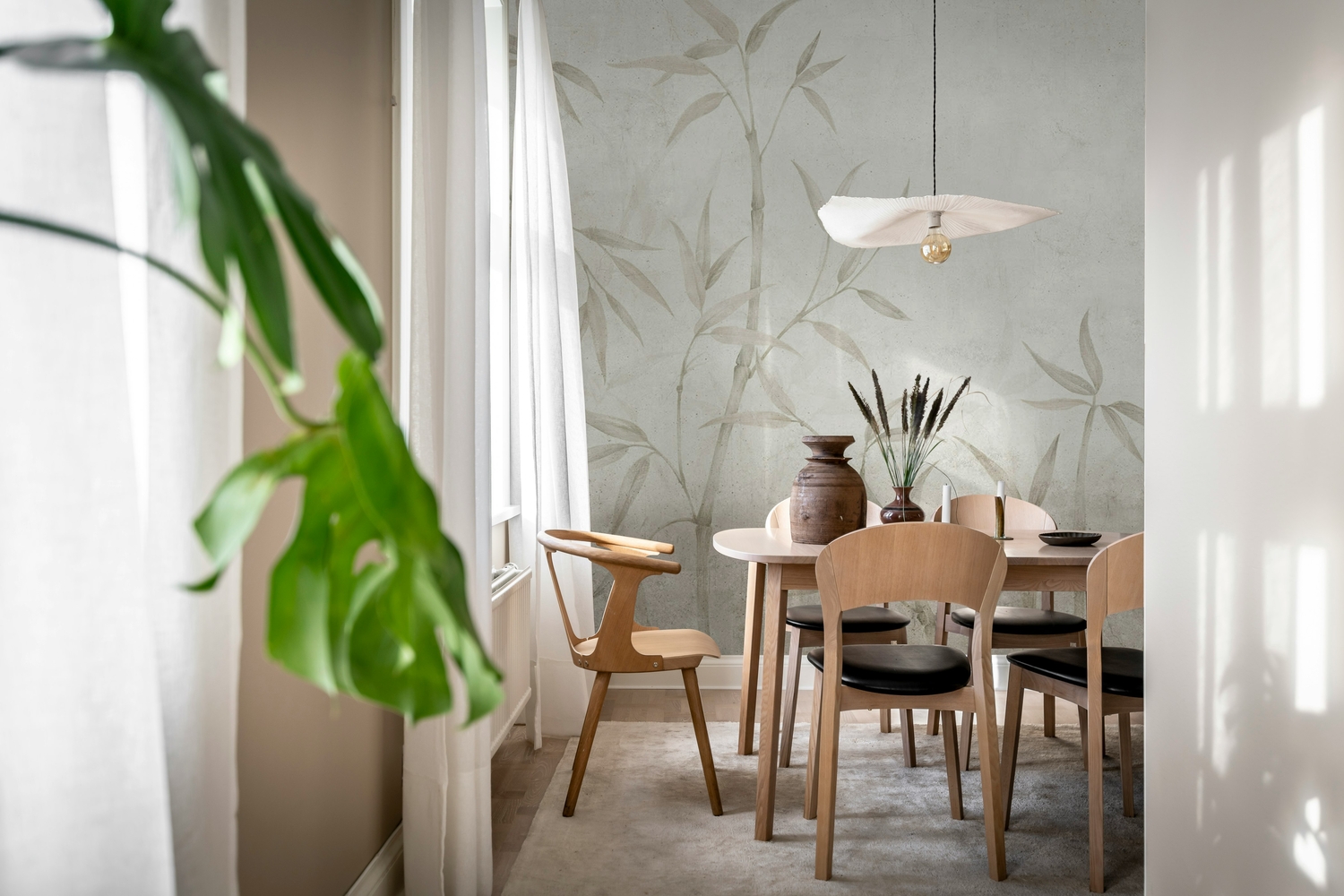 Bamboo Horizon mural wallpaper with tall bamboo stalks in neutral dining setting
