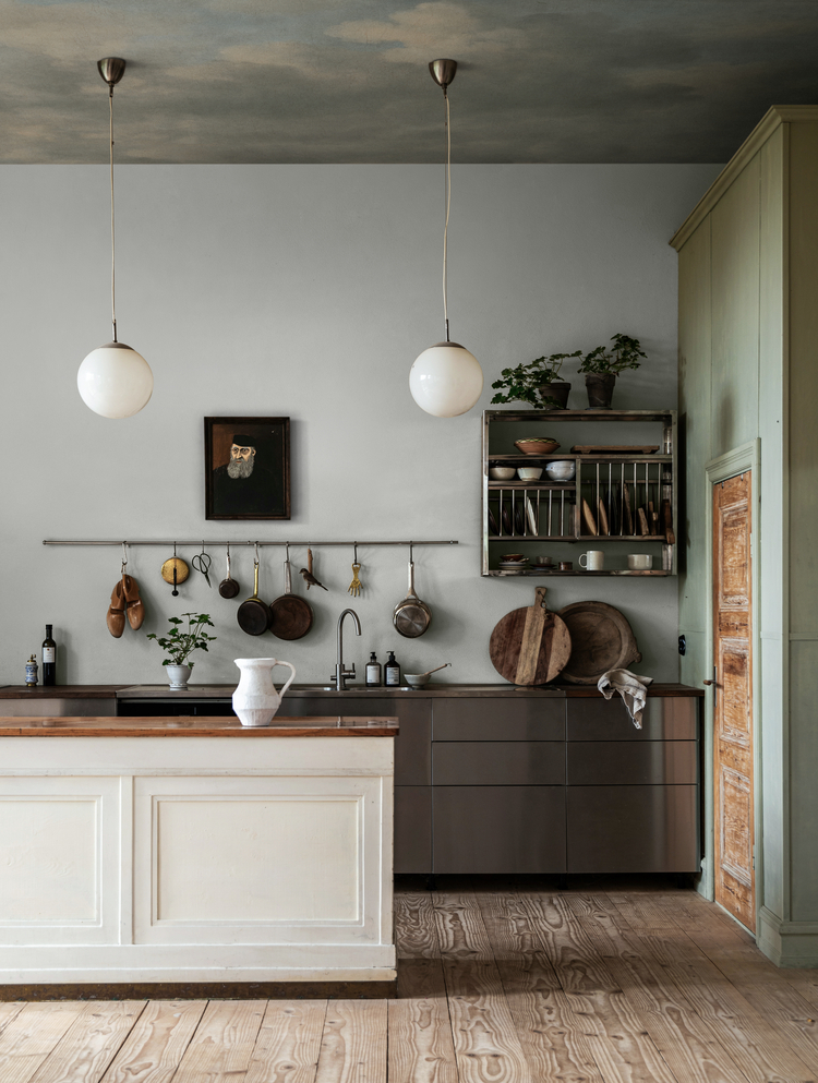 Vintage cloud mural wallpaper creating lightness in a dry kitchen