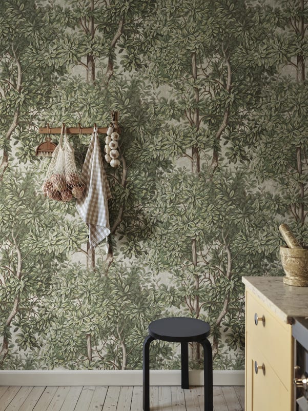 Green botanical wallpaper adding warmth and freshness to a kitchen interior