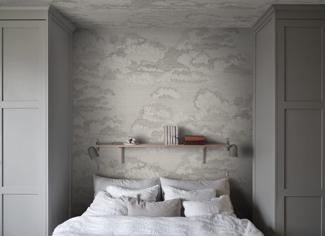 Light grey cloud pattern wallpaper in a calm bedroom setting