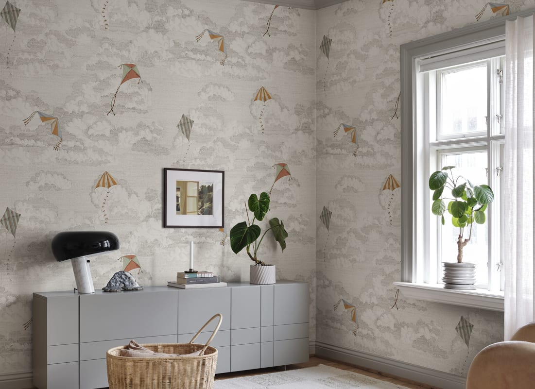 Light grey sky and cloud pattern wallpaper in a bright living room