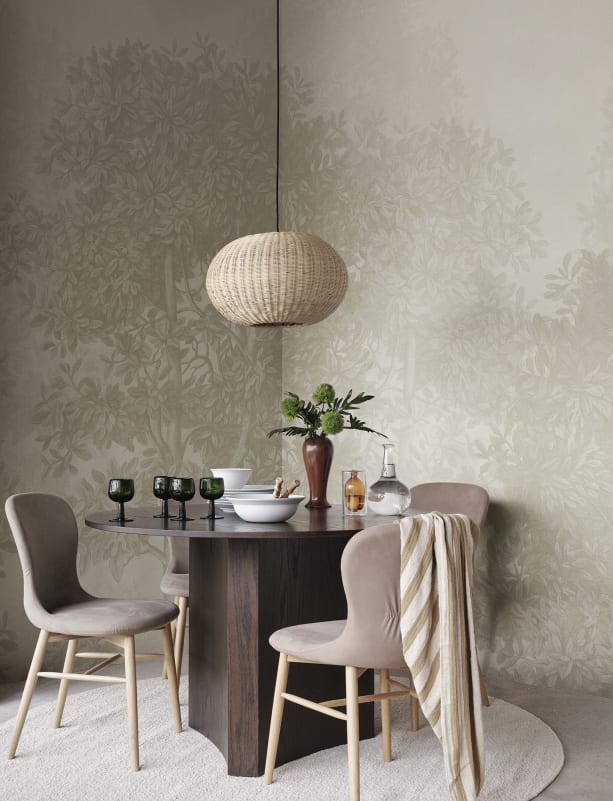 Vintage botanical wallpaper mural with forest trees in a dining room setting