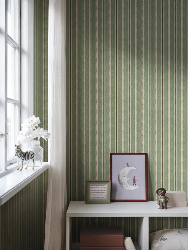 Dark sage green vertical striped wallpaper with hand-drawn, painterly finish, featured in kid's room