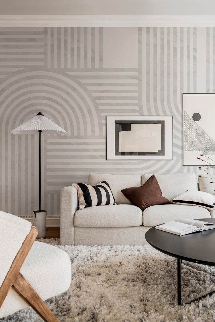 Stella Arch, Geometric Mural Wallpaper in grey featured in cozy modern scandinavian living room, filled with ivory linen couch, artistic monochrome wall decor. and lantern light stand